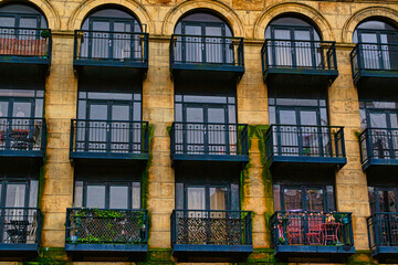 Facade of a vintage building with ornate windows and balconies in Leeds, UK.