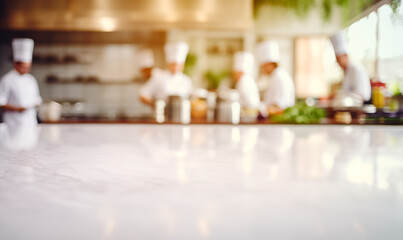 Empty white marble table background, chefs working in professional restaurant kitchen, copy space