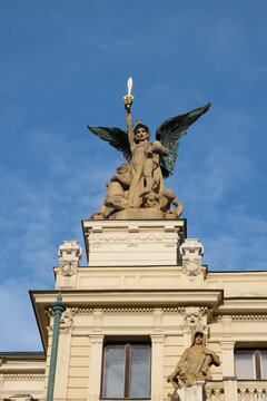 Prague, CZ -21.12.2021: Statue on the roof of a theater in Prague depicts a male angel with a sword and wings. Editorial