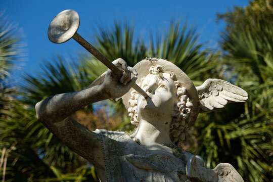 Statue of Mercury (Hermes) god of commerce, merchant and travelers.  Blowing a horn with wings on his hat outside.