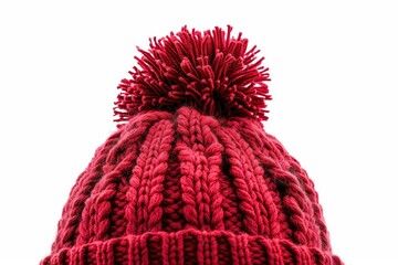 A cozy red knitted hat with a playful pom pom. Perfect for winter fashion. - obrazy, fototapety, plakaty
