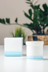 White plastic jar with cream and box, cosmetic product