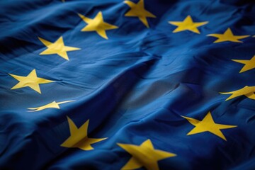 Detailed view of the European Union flag, featuring a circle of 12 gold stars on a blue background. - obrazy, fototapety, plakaty