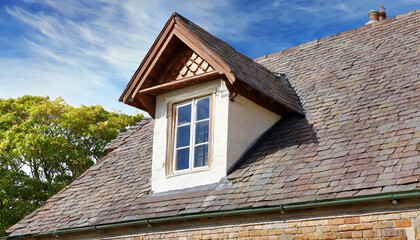 Fototapeta na wymiar window on the with slates covered roof