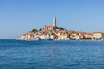 Fototapeta na wymiar View from the Adriatic Sea to peninsula with the Old Town and tower of Saint Euphemia Church, Rovinj, Croatia, Istria