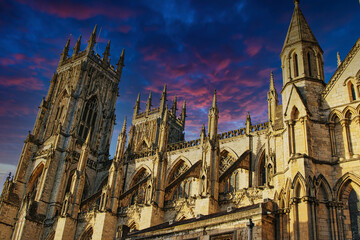 Majestic medieval cathedral against a vibrant sunset sky in York, UK.