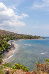Amed beach with many snorkeling tourists in water. Bali, Indonesia