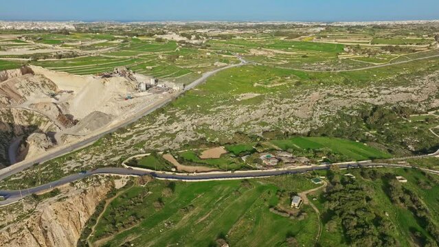 Aerial view of rocks, cliffs and green hills of Malta island, nature landscape. Lapsi, Mediterranean sea