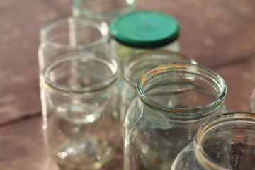 Empty washed glass jars of different volumes.