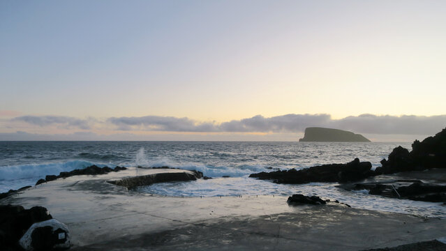 Volcanic natural swimming pool in Terceira Island (Azores) with Ilh&eacute;u das Cabras in the background
