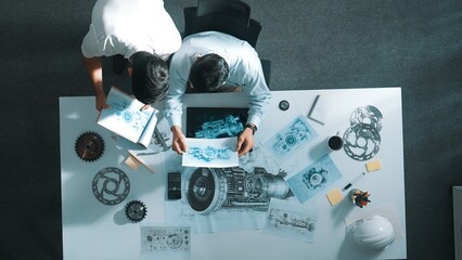 Top down aerial view of manager sitting while answer question about jet engine. Professional...