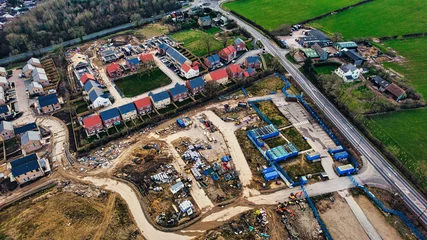 Poster Aerial view of a residential construction site with partially completed houses and infrastructure in Harrogate, North Yorkshire. © Vas