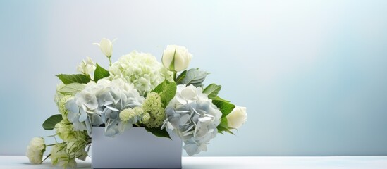 Hydrangea eucalyptus bouquet in white box on bright background