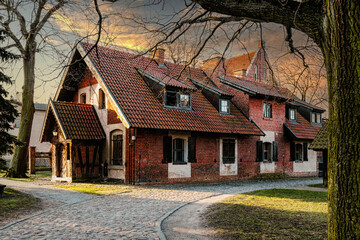 Street in the Baltic village. Old brick abandoned house in the traditional style	