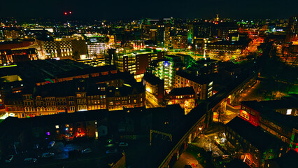 Cityscape at night with illuminated buildings and streets in Leeds, UK.