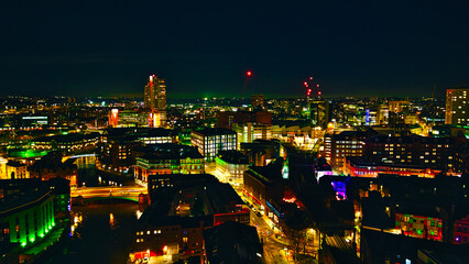 City skyline at night with illuminated buildings and vibrant urban lights in Leeds, UK.