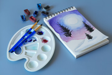 Christmas watercolor. Watercolor winter painting. Top view watercolor painting with a set of brushes, paints and palette 