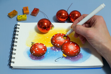 watercolor painting of red balls. Winter watercolor painting with a set of watercolor paints and paintbrushes. Top view
