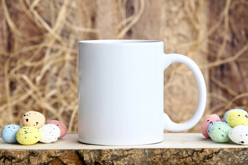 11 oz White Coffee Mug Mockup with Colorful Speckled Easter Eggs. Blank white mug On a wooden...