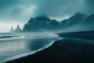 Scenic view of a black sand beach with majestic mountains in the background. Ideal for travel and nature concepts.