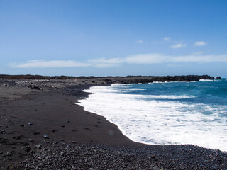Typical black sand beach of volcanic origin