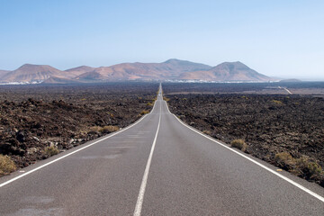 Perfectly straight road between the volcanic remains