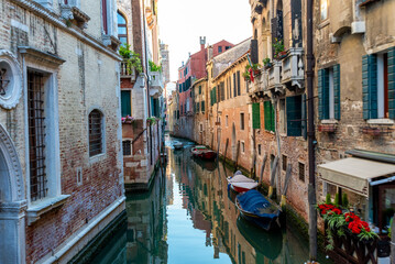 Fototapeta na wymiar Peaceful Canal Between Aging Buildings in Venice