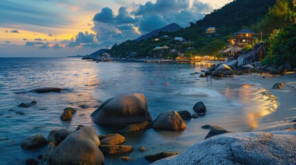 A beautiful sunset over a tranquil beach with rocks in the foreground. Perfect for travel and nature concepts.