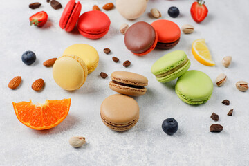 Colorful french dessert macarons with fresh fruits and nuts.