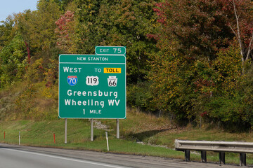 exit 75 sign for Greensburg, Pennsylvania and Wheeling, West Virginia via I-70, US-119 and PA-66,...