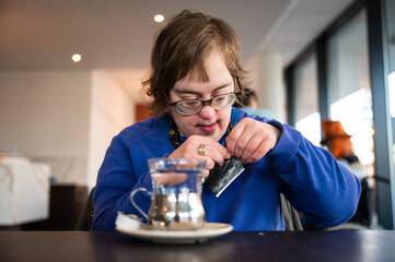 41 yo woman with the Down syndrome learning to brew tea, Belgium