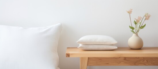 Handcrafted soft cushion on a wooden bedside table against white backdrop