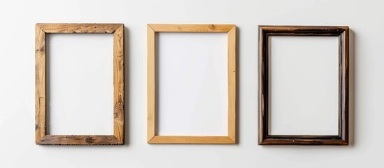 Three picture frames made of wood are mounted on a white wall, showcasing a sense of symmetry and artistry with their rectangular shape and various tints and shades