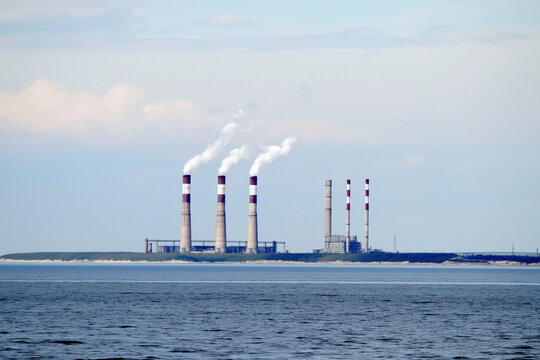 Industrial factory by large body of water