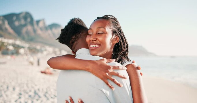 Couple, hug and smile in beach for vacation, holiday and date in city of Cape Town, fun and peace. Partners, black man and woman embrace with love, outdoor and sea in nature with mountain and happy