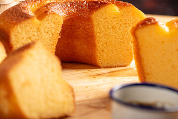 Orange cake and cup of coffee, beautiful orange cake and a cup of coffee and accessories on rustic wooden surface, dark background, selective focus.