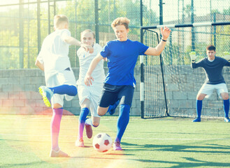 Teens playing soccer football match. Competition between two youth soccer teams. Football soccer...