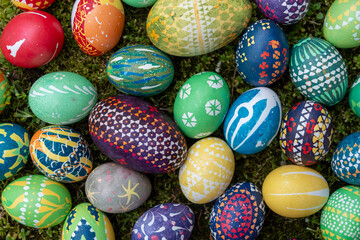 Fototapeta na wymiar many hand painted colorful easter eggs, according to Sorbian tradition outdoor in the moss