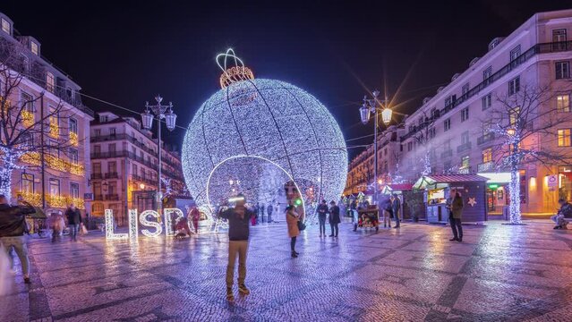Panorama showing Christmas decorations with big ball on Luis De Camoes square (Praca Luis de Camoes) night timelapse. One of the biggest squares in Lisbon city in Portugal illuminated in the evening