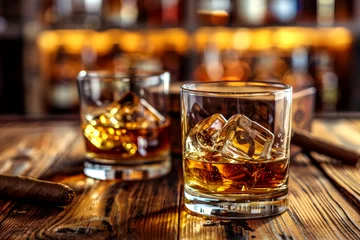 Fotobehang a glass of strong whiskey with ice and cigars stand on a wooden bar counter against the background of the bar © MK studio