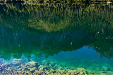 Transparent water of Lake Gosausee. Reflection of mountains in the clear water of Lake Gosausee on Salzkammergut, Austria. Tourism in Europe.