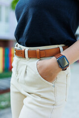 Women's leather belt for trousers. A brown belt on a woman's waist