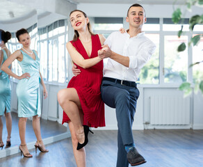 Man and girl take dance lessons from experienced teacher. Couple in stage costumes practices boogie...