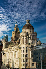 Fototapeta na wymiar Stunning architecture against a blue sky with dramatic clouds in Liverpool, UK.