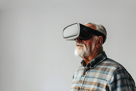 Senior man with virtual reality headset. Male in VR glasses on gray background. VR, AR, metaverse, future, gadgets, technology, education online, study, video game concept. Futuristic technology