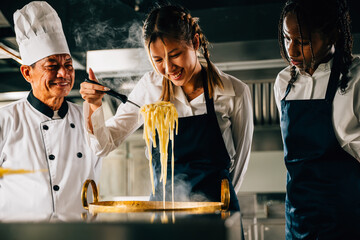 In kitchen chef teaches students. Schoolgirls craft ramen. Kids and teacher at stove. Smiling...