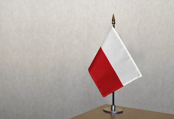 Poland table flag on gray blurred background