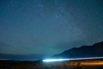 Car tail light trails in the Mojave Desert shortly after sunset