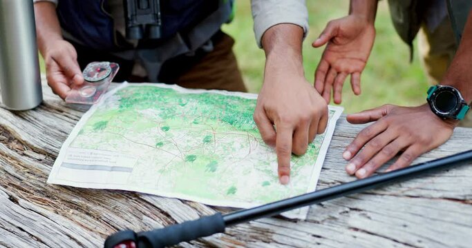 Map, hands and hike of people with compass, direction and travel with guide in nature for trekking. Navigation, camping and outdoor with paper, journey and holiday with trail information and plan