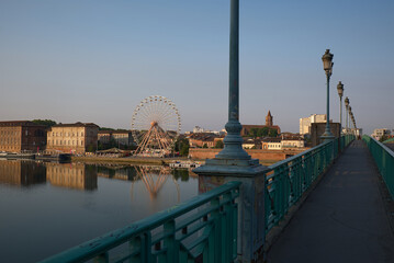 Tranquil morning scene at Pont Saint-Pierre Bridge in Toulouse, France. Historic bridge spans...